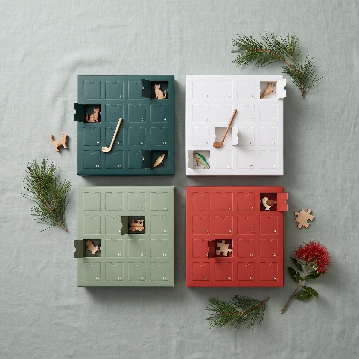 Four themed advent calendars with wooden ornaments