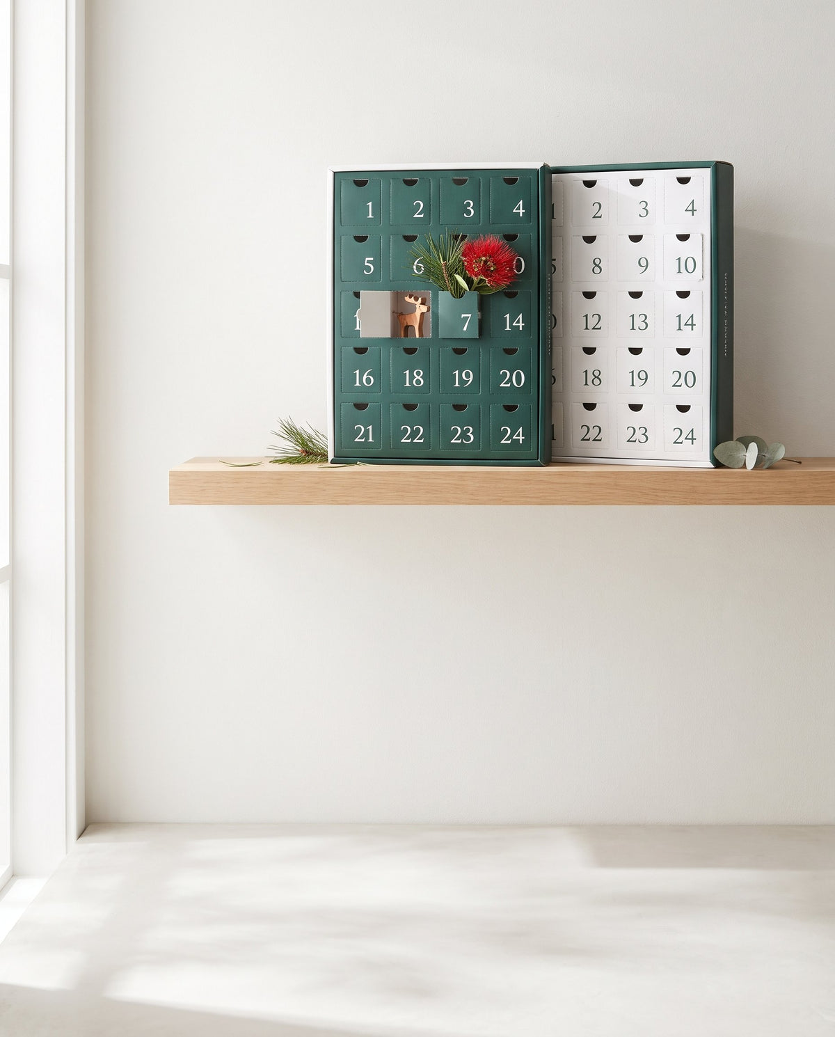 Advent calendars on a shelf with pohutukawa